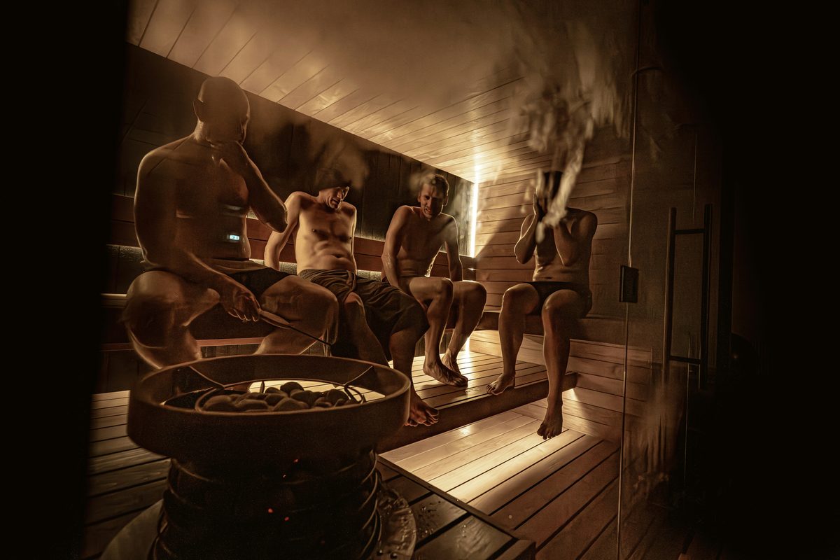 People relaxing in a wooden sauna