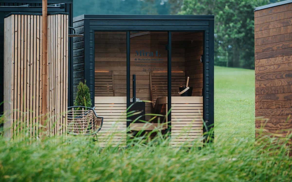 Outdoor wooden sauna cabins in a grassy field