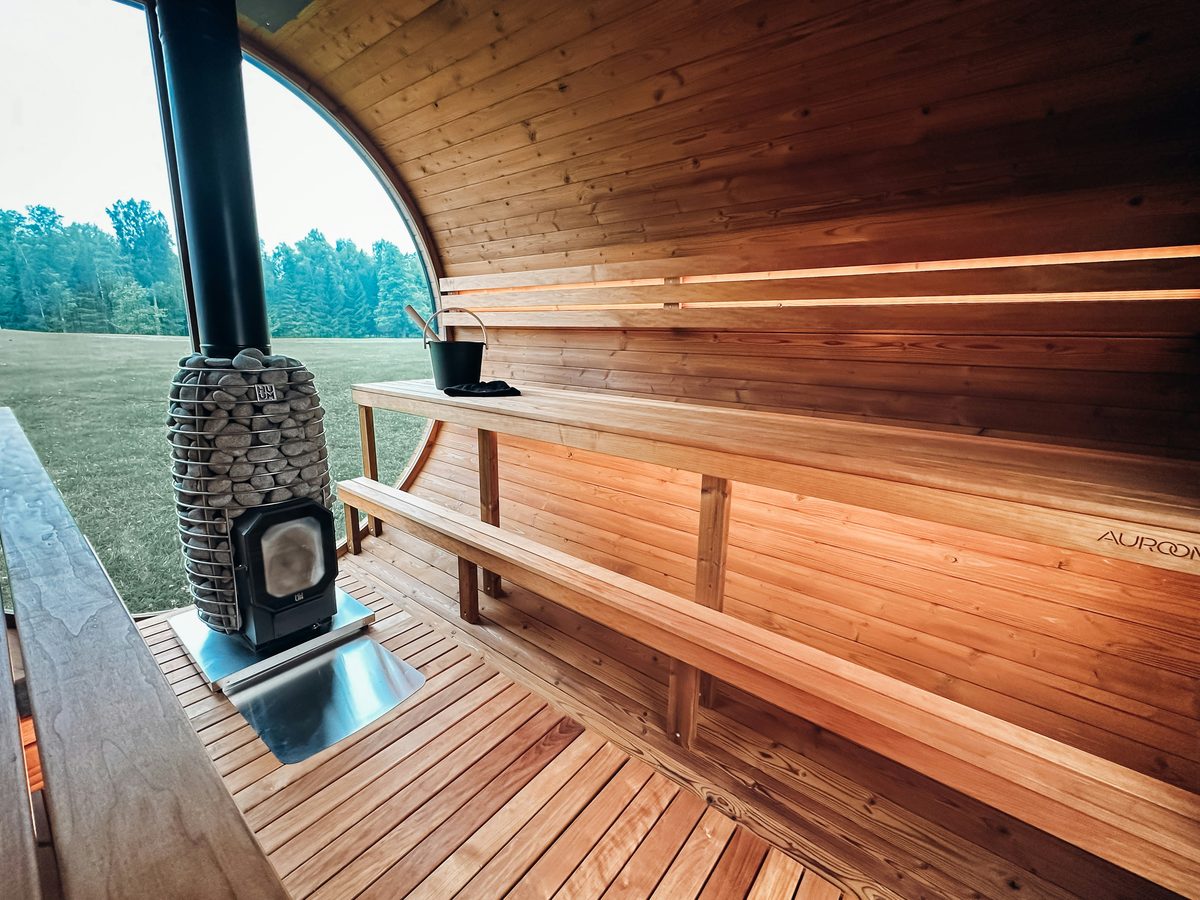 Traditional sauna interior with wood-burning stove and benches